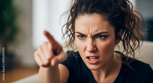 Woman pointing, expressing anger, frustration, and disapproval.