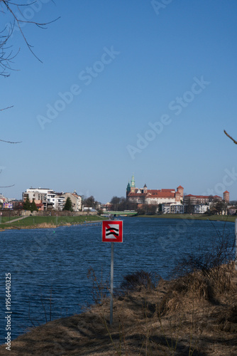 Krakow Wawel Castle and Vistula River with warning sign on a clear day