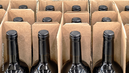 Rows of dark glass wine bottles in corrugated cardboard packaging.