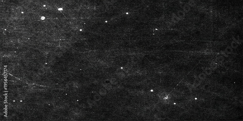 A dark grunge texture with black and white stars scattered across a rough vintage concrete wall like a snowy grey space background