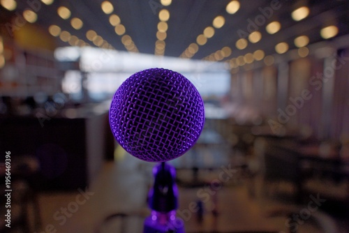 Classic Vintage Microphone Close-up in Purple Light, Warm Soft Bar Background with Bokeh. Classic Mic Bathed in Purple Light, Soft Warm Pub or Nightclub Atmosphere with Bokeh