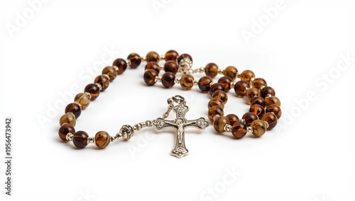Traditional Catholic rosary featuring marbled brown glass beads and a silver cross, displayed on a white background, representing Christian faith.