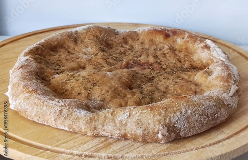 Whole wheat focaccia bread on wooden board