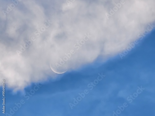 Waxing Crescent Moon Emerging from Daytime Clouds