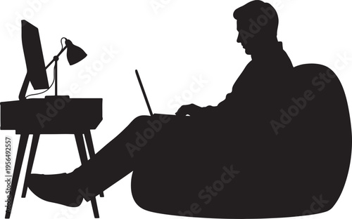 Man Silhouette Working on Laptop in Beanbag Chair at Desk
