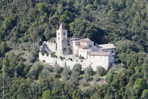 The Benedictine Abbey of San Cassiano near Narni, Umbria, Terni, Italy. The green hills covered by the forest. Distance view. View from the medieval town of Narni. Umbria region, central Italy. 