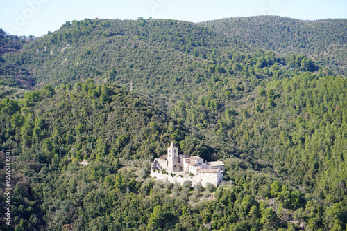 The Benedictine Abbey of San Cassiano near Narni, Umbria, Terni, Italy. The green hills covered by the forest. Distance view. View from the medieval town of Narni. Umbria region, central Italy.