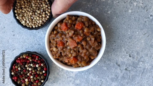 Lentil, carrot, and tomato stew with sausages, a European dish. Lentils with sausages as a food background for your design