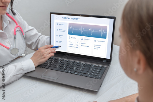 doctor presenting digital medical report on laptop to patient representing health data analytics and healthcare software interface