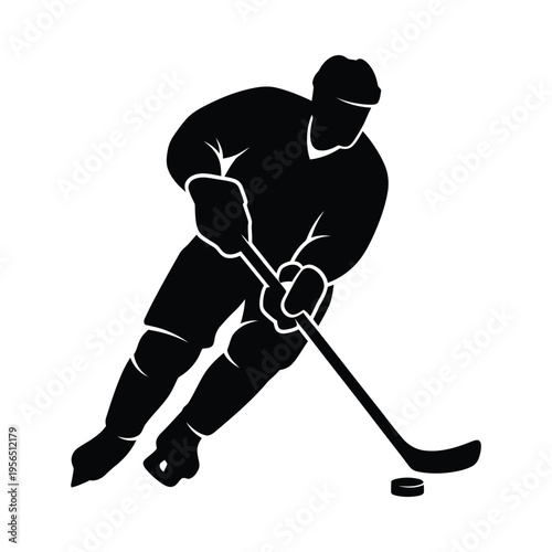 Silhouette of a hockey player in action, skating and handling the puck on the ice rink