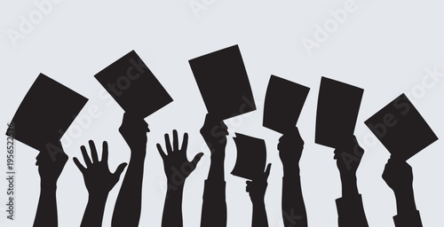 Silhouettes of hands holding up cards, representing voting, protest, or auction participation.
