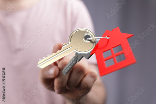 Person presenting house key...