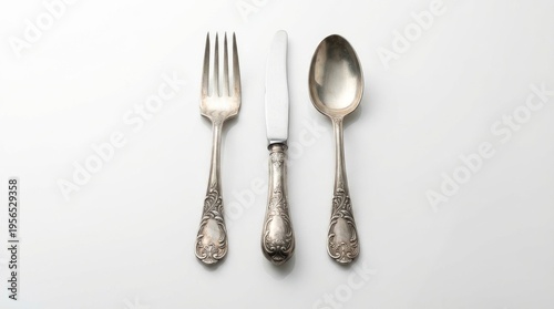 Vintage Ornate Silver Fork Knife and Spoon Isolated on White Background Represents Luxury Fine Dining and Elegant Tableware Concept