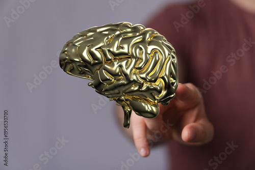 Person holding golden brain...