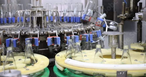 Empthy bottles on a conveyor belt in bottling process at a factory