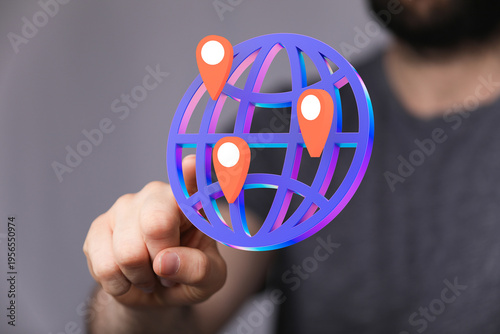 Hand pointing at a globe wi...