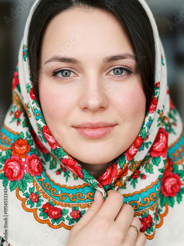 Portrait of a young beautiful woman with a scarf on her head
