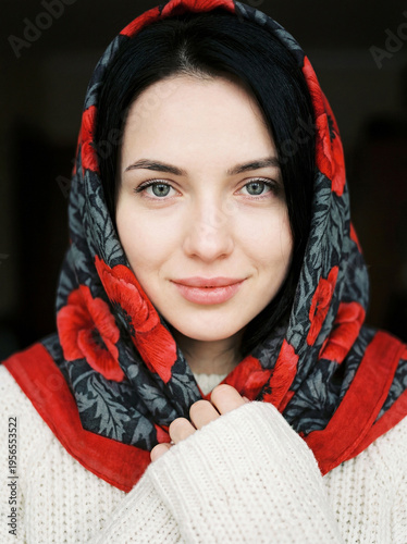 Portrait of a young beautiful woman with a scarf on her head