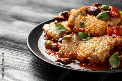 Chicken Puttanesca with capers, olives, tomatoes and anchovies. Italian food