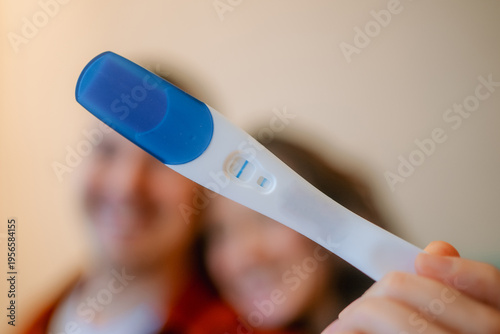 Tableau sur toile Woman holding positive pregnancy test, showing two lines, confirming pregnancy w