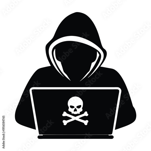 Silhouette of hooded hacker works on the laptop displaying skull and crossbones symbol