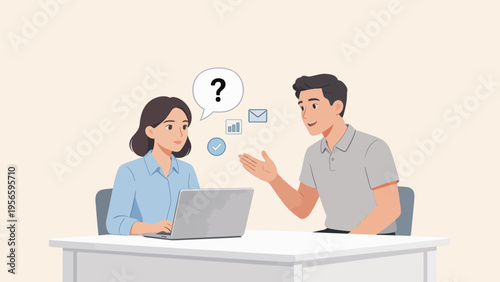 Two people discussing at a desk