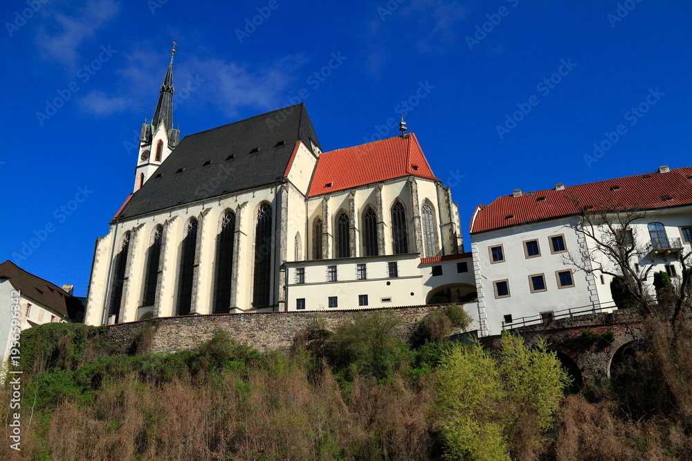 Fototapeta premium Historic Cesky Krumlov Castle Complex and St Vitus Church Reflected in Vltava River