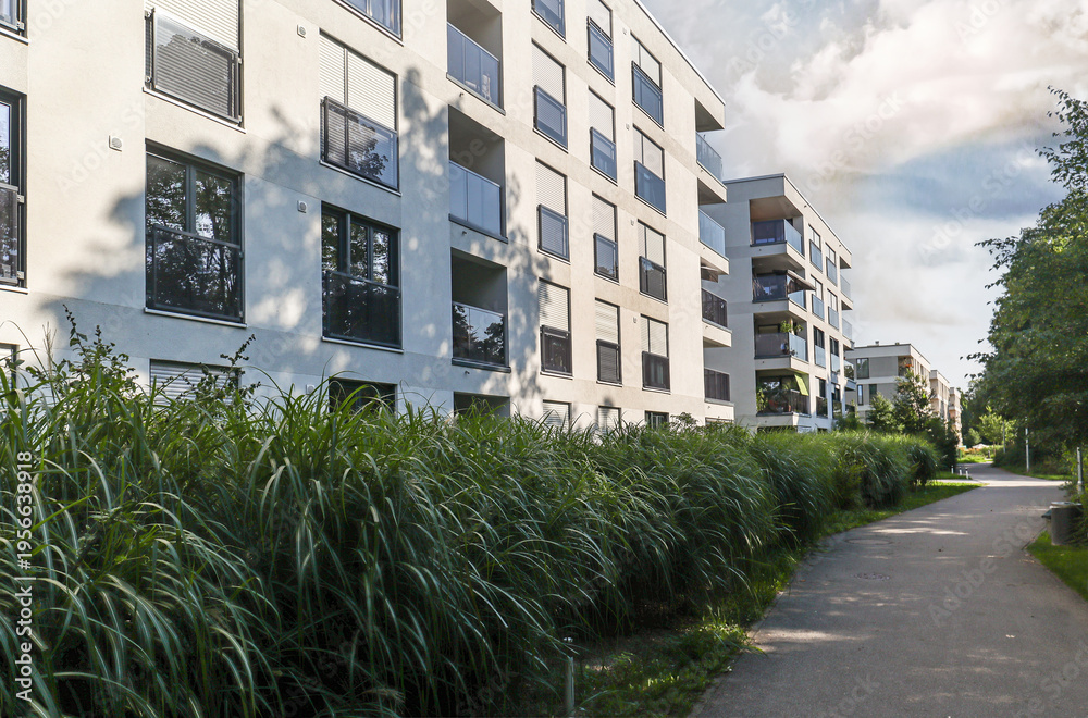 Fototapeta premium Cityscape of a residential area with modern sustainable apartment buildings, new green urban landscape in the city