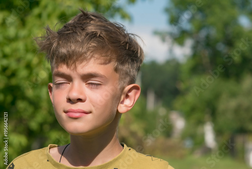 Portrait image of a teenage boy outside the city