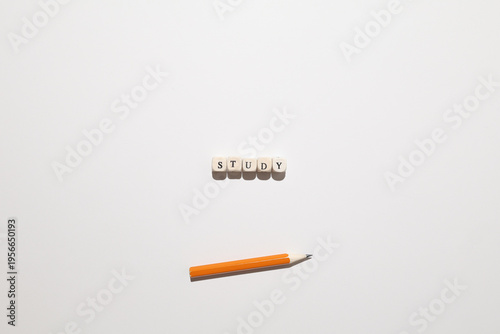 Word STUDY spelled with letter tiles above a pencil representing learning, studying, and academic preparation. Free Download Word STUDY spelled with letter tiles above a pencil representing learning, studying, and academic preparation. - GFXLoad
