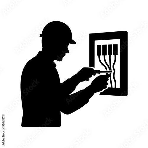 Silhouette of a man working on an electrical panel with a screwdriver tool