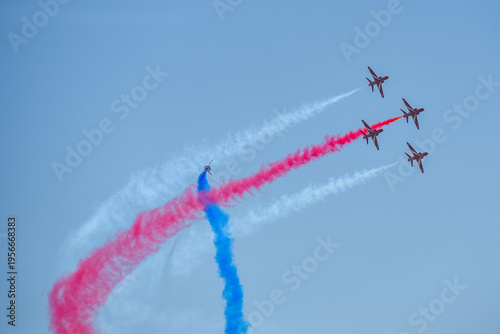 A group of aerobatic jet aircraft flying in perfect formation du