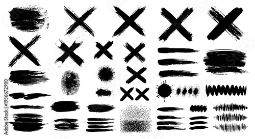 Collection of various black brush strokes and marks on white background.