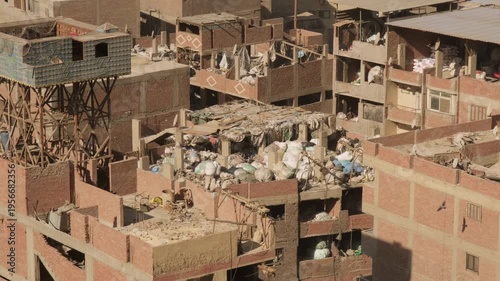 Residential buildings with bales of garbage on lids for recycling at Garbage City in Manshiyat Naser on outskirts of Cairo
