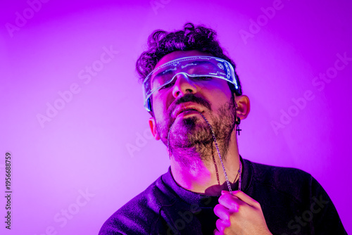 Konstfotografi Man in glowing futuristic glasses exploring augmented reality under neon purple