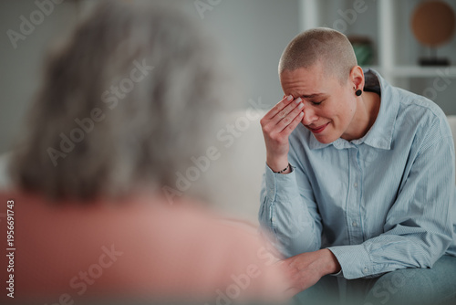 Young woman crying during therapy session with counselor