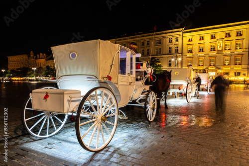 Horse carriages in Krakow at night, Poland