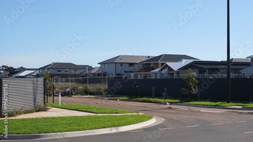 New suburban housing in Truganina, Melbourne, Australia, with modern homes bordering undeveloped land and empty lots. Rapid urban expansion of growing outer suburbs.