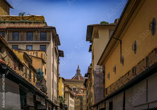 Weathered medieval stone buildings of Ponte Vecchio stand in Florence, Italy