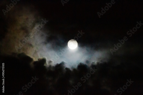Slika na platnu Full moon with colorful clouds rising from below