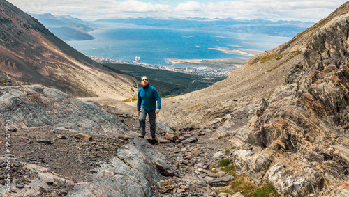 Bild auf Leinwand Hiker reaching the top of a hill overlooking the Martial Glacier mountains in Us