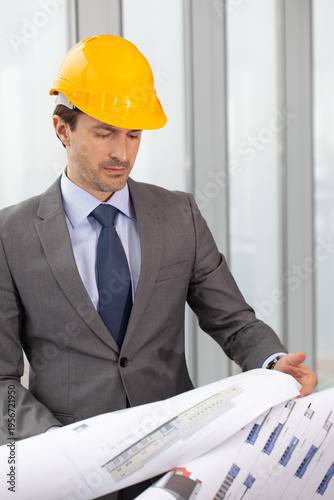 A builder studies a construction plan