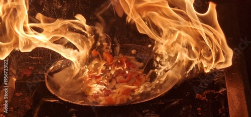 Golden and amber flames  above a frying pan