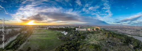 Fotografie Dramatic aerial panorama of Lucera town and castle with blue, orange, yellow sun