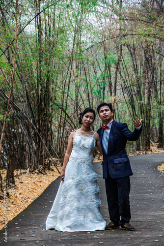asia marry wed on road in bamboo forest