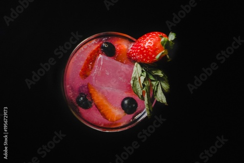 Billede på lærred elegant glasses with vibrant refreshing cocktails garnished with fresh berries, apple slices, cucumber, citrus and rosemary