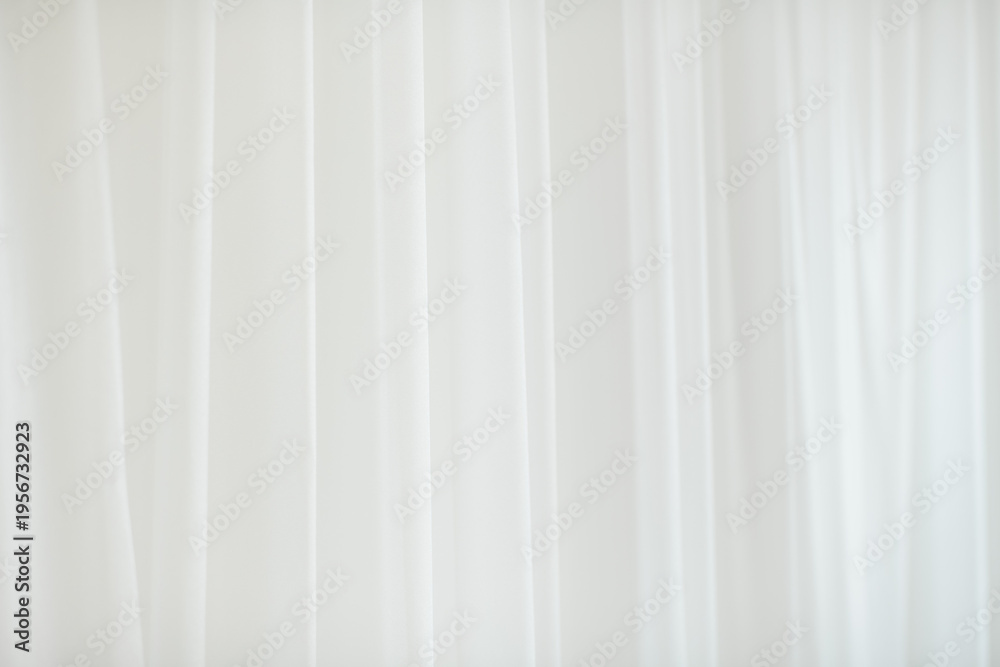 Fototapeta premium Soft white fabric background with subtle vertical folds and gentle texture, creating a clean, airy, and minimal backdrop ideal for product displays, branding, or copy space
