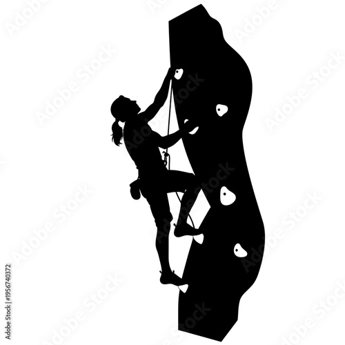 A woman climbs an indoor rock wall with determination and strength in a fitness setting.