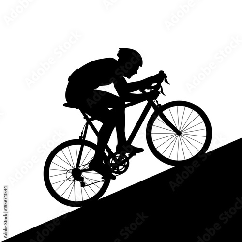 Cyclist rides bicycle uphill with effort and determination on a slope.