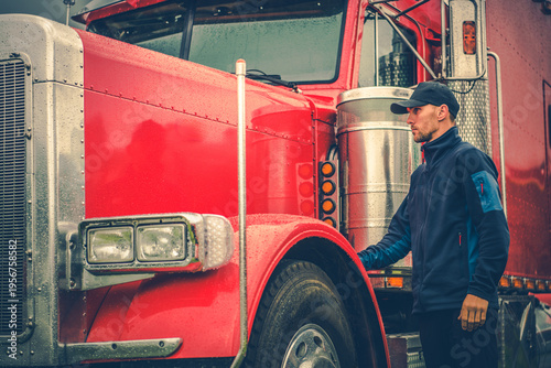 Fotografie Truck Driver Inspects Red Vehicle at Truck Stop